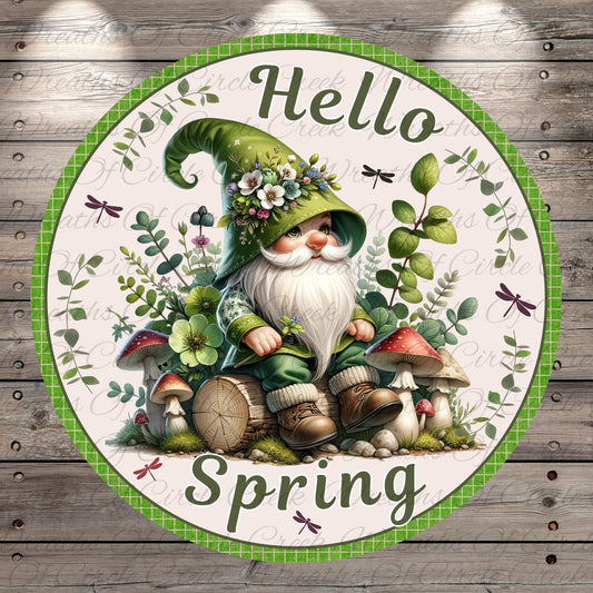 A gnome wearing a green hat and surrounded by mushrooms, flowers, and leaves sits on a log, with the text "Hello Spring" displayed around the gnome.