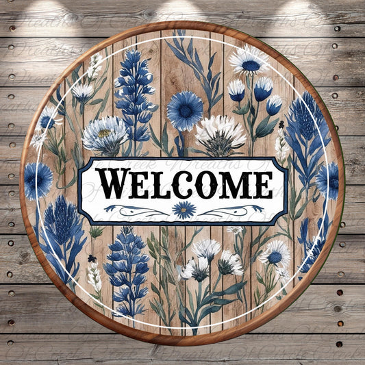 a welcome sign with blue and white flowers on a wooden background