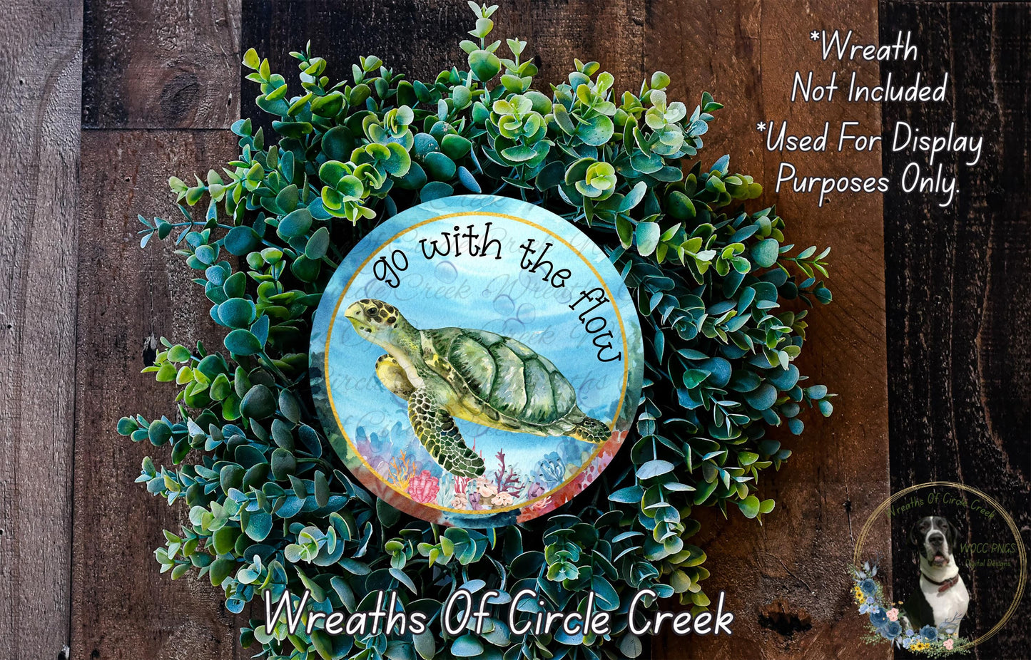 A wreath made of green plants and a circular design featuring a turtle, with the text "Go with the flow" written on it.