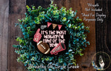 A wreath made of green foliage and a football, with the text "It's the most wonderful time of the year!" displayed on it.