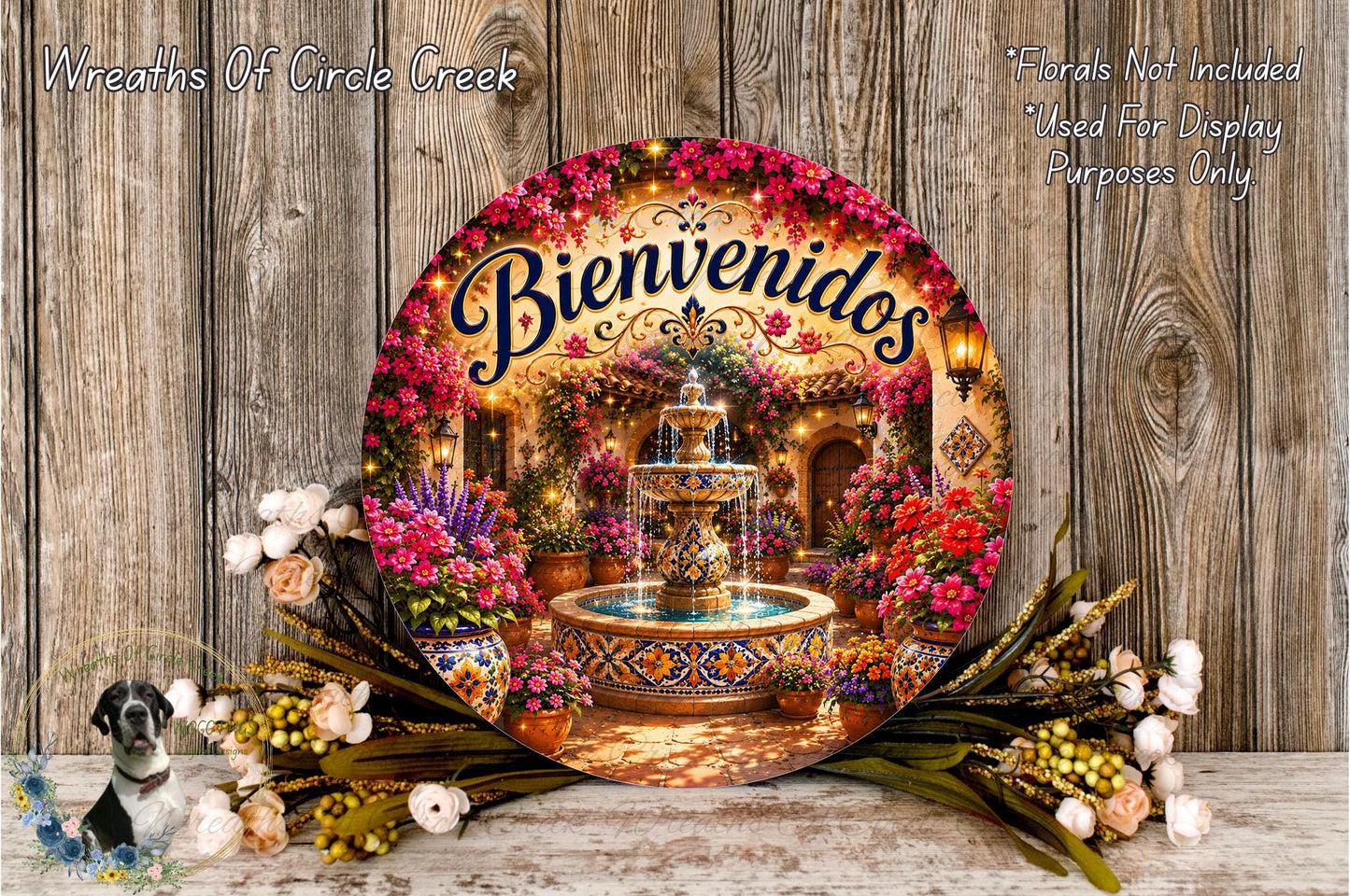 a decorative wreath with a fountain and flowers, surrounded by a floral arrangement and a bird. The wreath has the text "Bienvenidos" written on it, which translates to "Welcome" in Spanish.