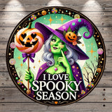 a sign with a witch holding a pumpkin and a jack - o - lantern