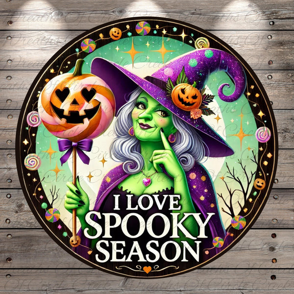 a sign with a witch holding a pumpkin and a jack - o - lantern