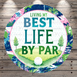 The image is a circular graphic with a golf-themed design, featuring a golf ball, trees, and a golf course. The text "LIVING MY BEST LIFE BY PAR" is prominently displayed in the center of the image.