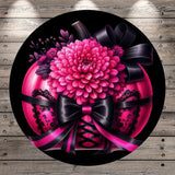 A large, vibrant pink flower with a black ribbon and lace-up design sits atop a pink and black corset-style bust.