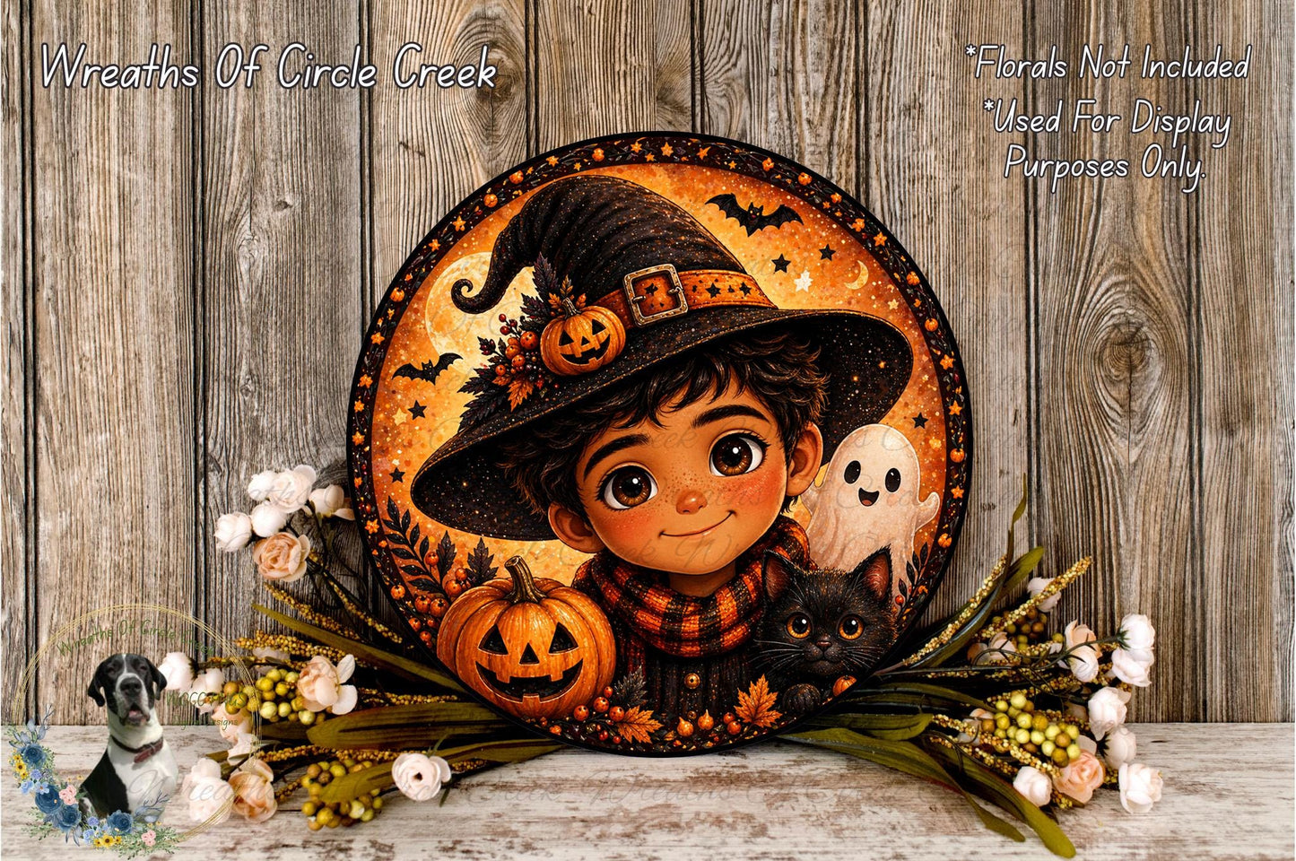A Halloween-themed wreath featuring a young boy wearing a witch's hat, holding a jack-o-lantern and a ghost, surrounded by autumn foliage and flowers.