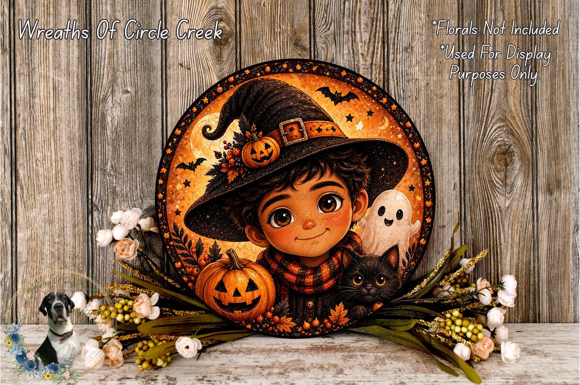A Halloween-themed wreath featuring a young boy wearing a witch's hat, holding a jack-o-lantern and a ghost, surrounded by autumn foliage and flowers.