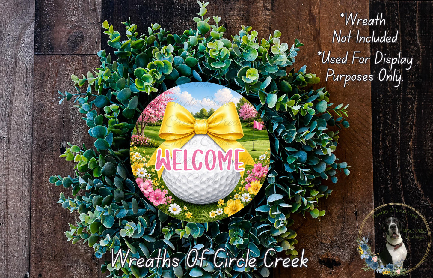 a wreath with a golf ball and a yellow bow, surrounded by greenery and flowers, with the word "WELCOME" displayed on the golf ball.
