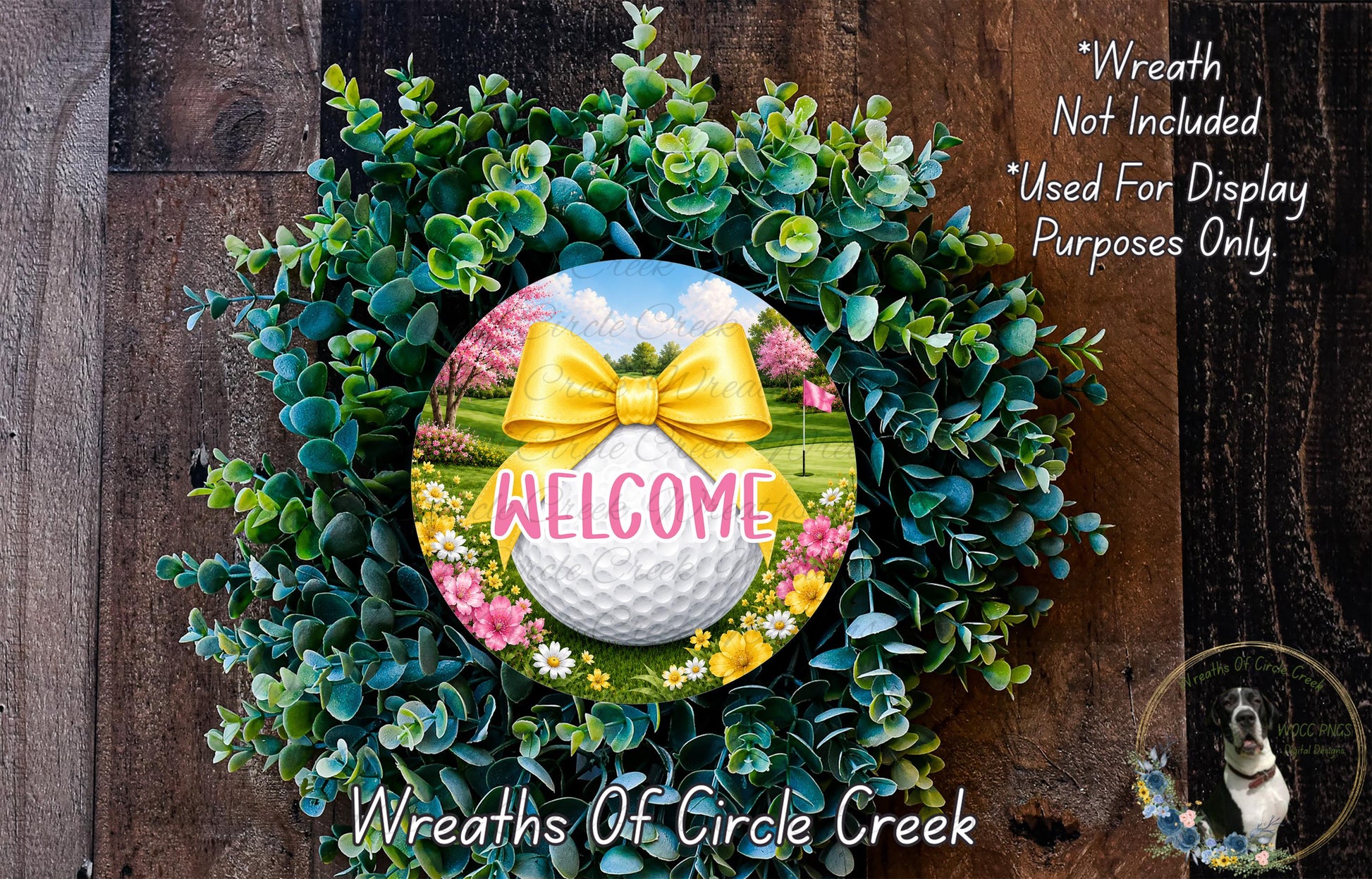 a wreath with a golf ball and a yellow bow, surrounded by greenery and flowers, with the word "WELCOME" displayed on the golf ball.