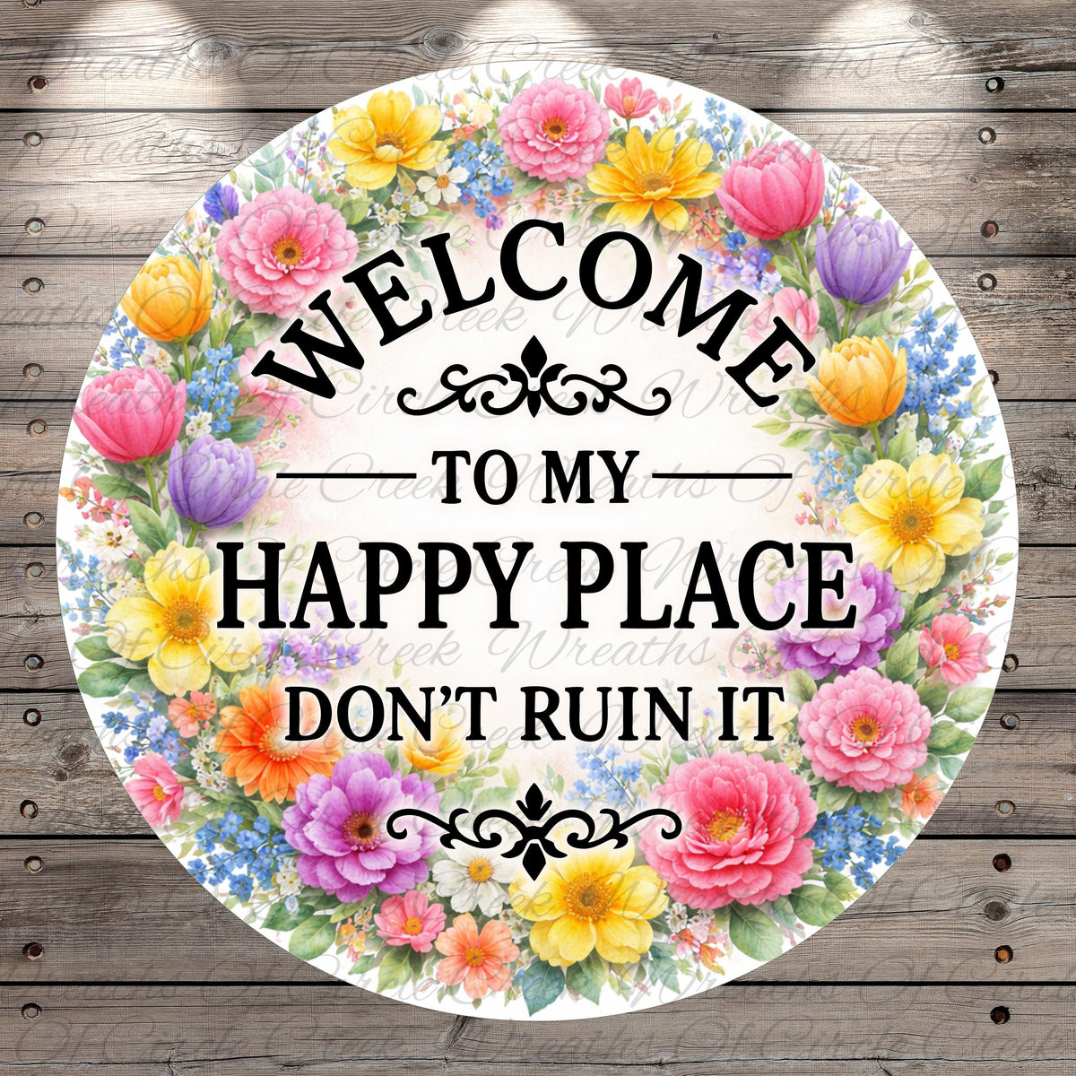 A circular sign with a floral border and the text "Welcome to my happy place don't ruin it" written on it.