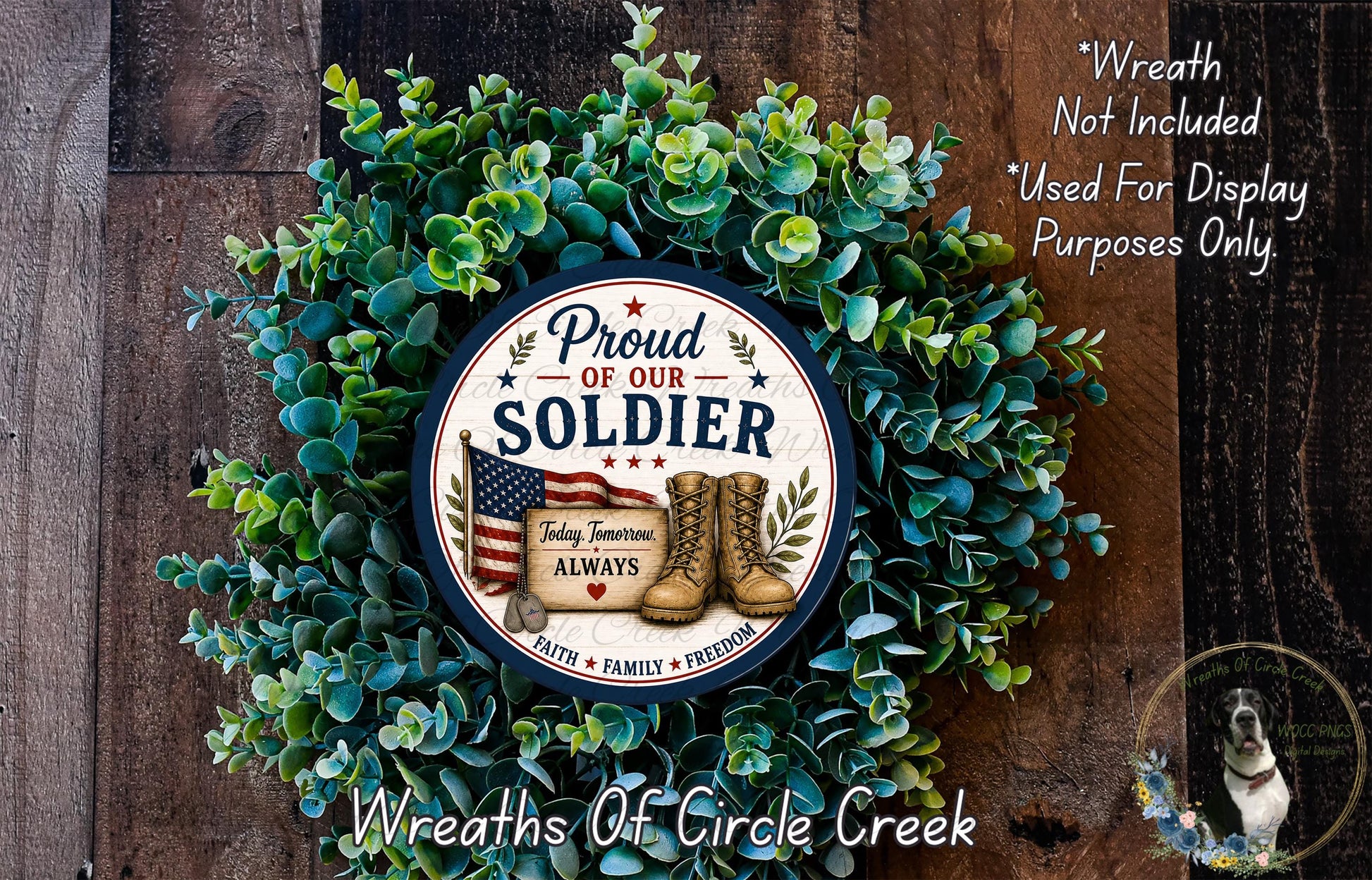 A wreath made of green leaves and a circular sign with a patriotic design, including an American flag and a pair of boots, is displayed on a wooden surface.