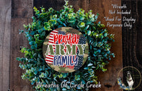 a wreath made of green leaves and a patriotic American flag design, with the text "Proud Army Family" prominently displayed in the center.