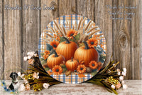 a round wooden plaque with a vibrant autumnal design, including pumpkins, flowers, and a plaid pattern. The plaque is placed on a wooden surface, surrounded by a floral arrangement.