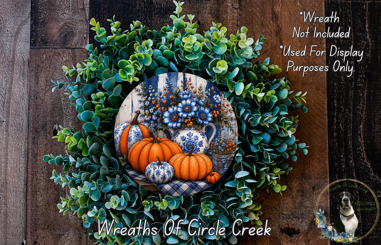 a wreath made of various fall-themed elements, including pumpkins, flowers, and greenery, set against a wooden background.