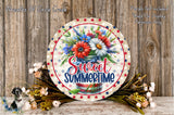 a decorative round sign with a floral arrangement and the text "Sweet Summertime" displayed on it, placed on a wooden surface.
