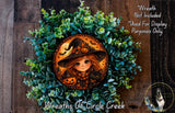 A wreath featuring a cartoon illustration of a young girl wearing a witch's hat, holding a pumpkin and a cat, surrounded by green foliage.