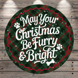 A circular Christmas-themed sign with the text "May Your Christmas Be Furry & Bright" against a plaid background with snowflakes.