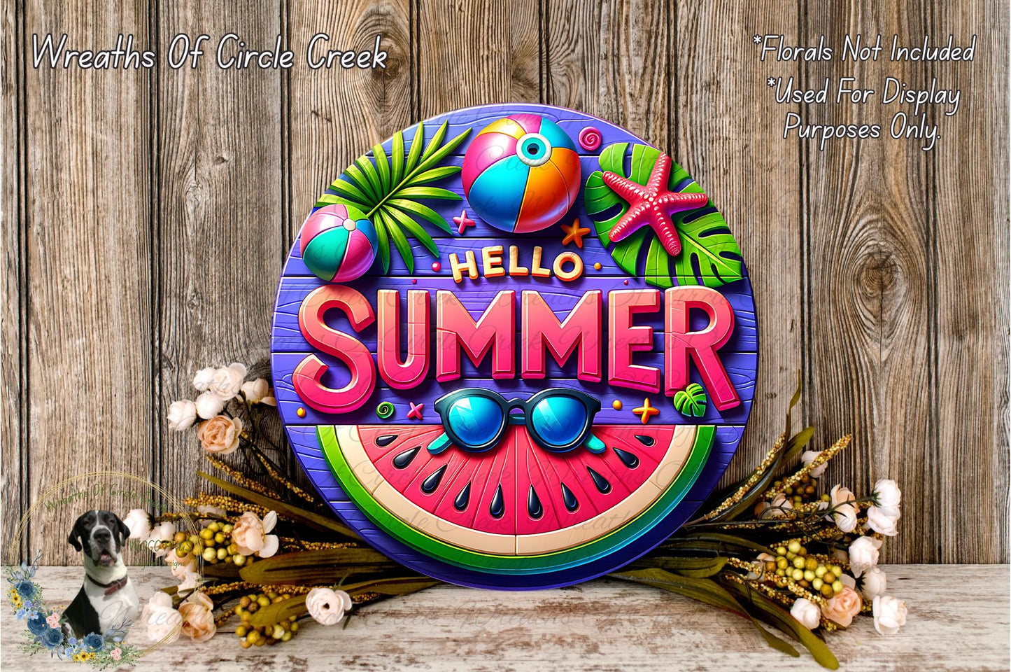A colorful sign with the text "Hello Summer" surrounded by various summer-themed elements such as a watermelon slice, palm leaves, a beach ball, and a starfish. The sign is displayed on a wooden surface, with flowers and greenery arranged around it.