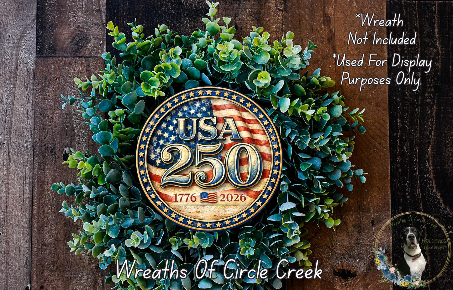 A wreath made of green leaves and a circular emblem with the text "USA 25" and "1776-2026" on it, placed on a wooden surface.