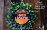 a wreath made of green foliage and a football, with the text "Toiletries & Touchdowns" written on it. The wreath is displayed on a wooden surface, and there is a small dog in the bottom right corner of the image.