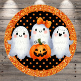 A Halloween-themed illustration featuring three cheerful ghost characters with a carved pumpkin in the center, all set against a glittery black and orange background.
