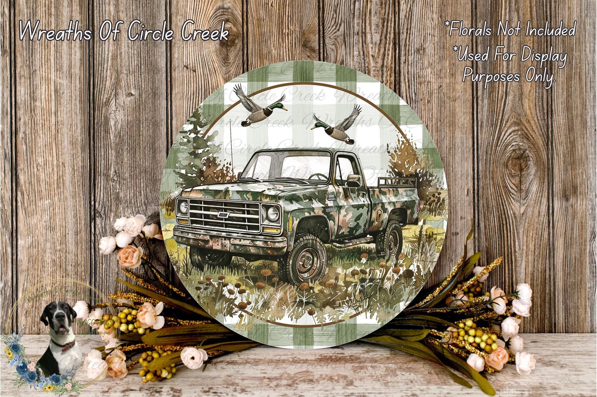 a round, decorative plate with a camouflage truck and a pair of ducks in flight, surrounded by a wreath of flowers and foliage.