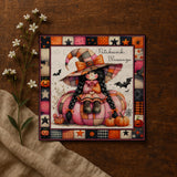 A framed illustration of a young girl dressed as a witch, sitting on a pumpkin and surrounded by Halloween-themed elements such as bats, pumpkins, and flowers.