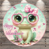A whimsical illustration of a frog wearing pink glasses and a pink bow, surrounded by hearts and the text "Happy Valentine's Day!"
