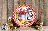 A decorative plate with a red and white checkered border, featuring illustrations of various vegetables and a pot of food, along with the text "Let the good times boil". The plate is surrounded by a floral arrangement and placed on a wooden surface.