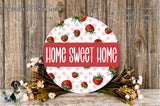 a round sign with the text "HOME SWEET HOME" in bold red letters, surrounded by a floral arrangement of pink and white flowers.