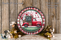 a round wooden plaque with a red truck and a sign that reads "Special Delivery", surrounded by flowers and greenery.