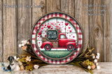 a round wooden plaque with a red truck and a sign that reads "Special Delivery", surrounded by flowers and greenery.