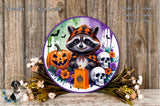 A Halloween-themed wreath featuring a raccoon wearing a hooded cloak, a carved jack-o-lantern, and two skull decorations, surrounded by colorful flowers and greenery.