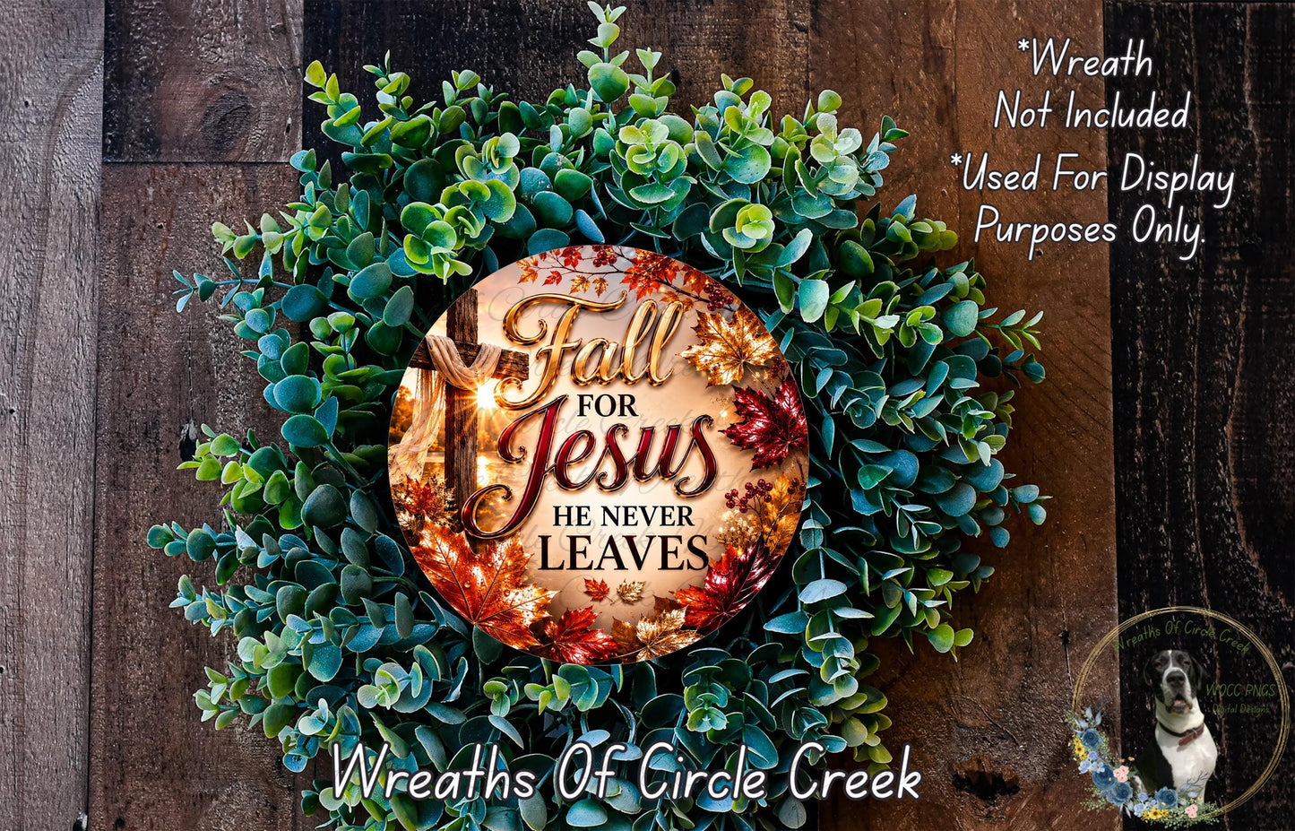 a wreath made of green leaves and a circular ornament with the text "Fall for Jesus he never leaves" displayed on it.