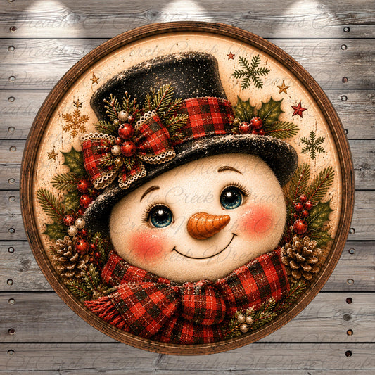 A snowman with a black top hat, red and black plaid scarf, and a carrot nose, surrounded by pine cones, berries, and snowflakes, all set against a wooden background.