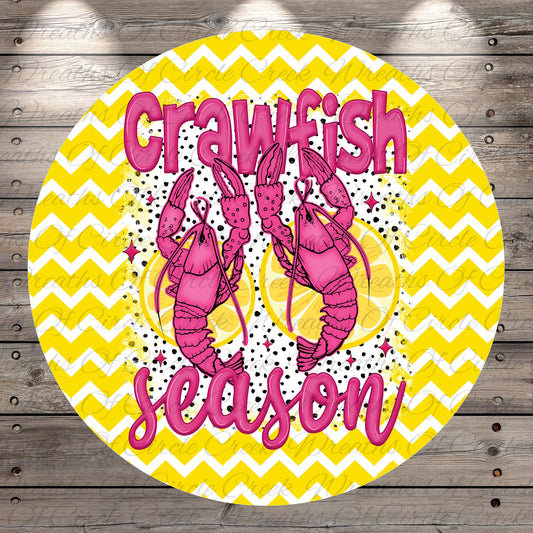 a circular design with a yellow and white chevron pattern, and two pink lobsters holding lemons. The text "Crawfish season" is written in pink letters above the lobsters.