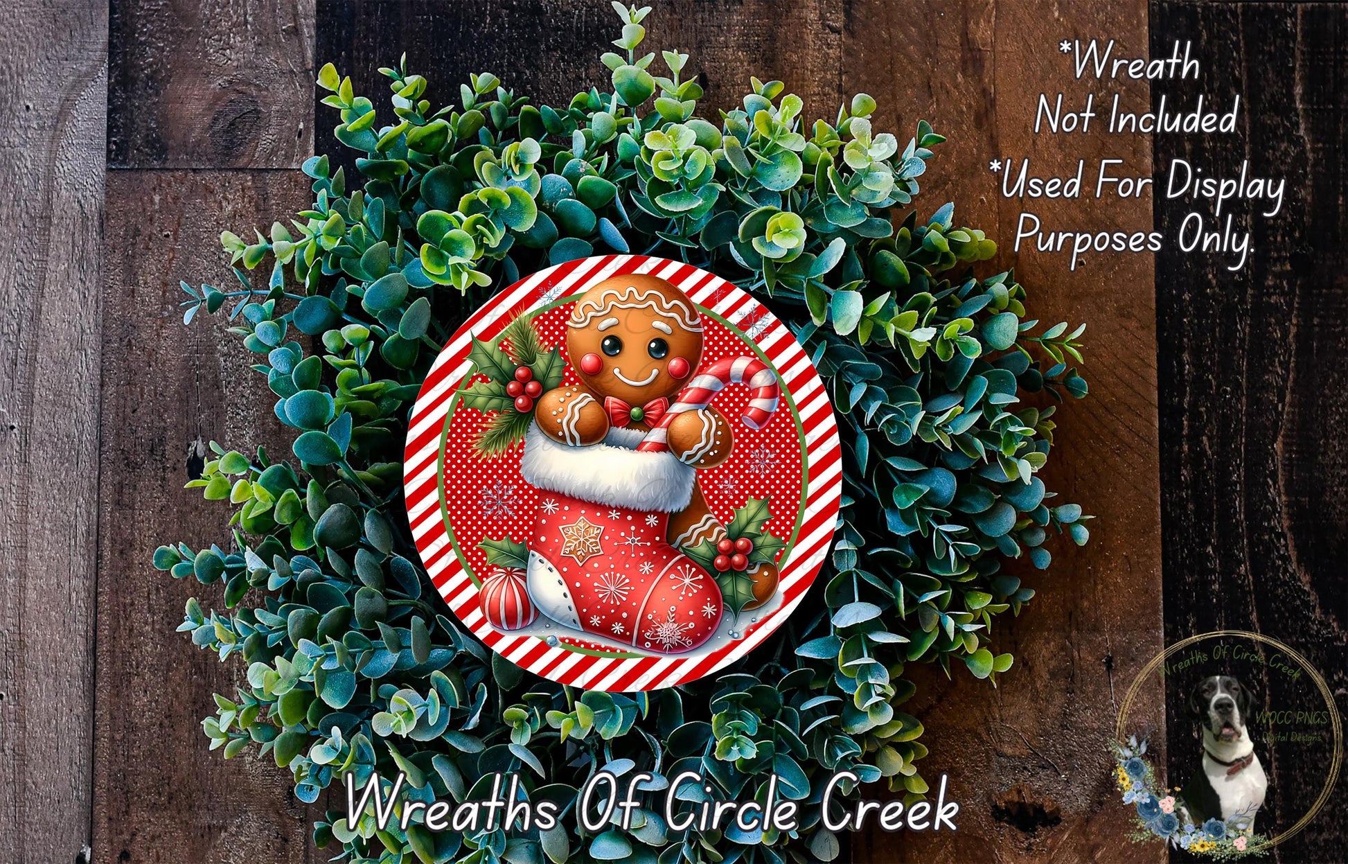 A wreath made of green foliage and a gingerbread man figure, with a red and white striped border, is displayed on a wooden surface.