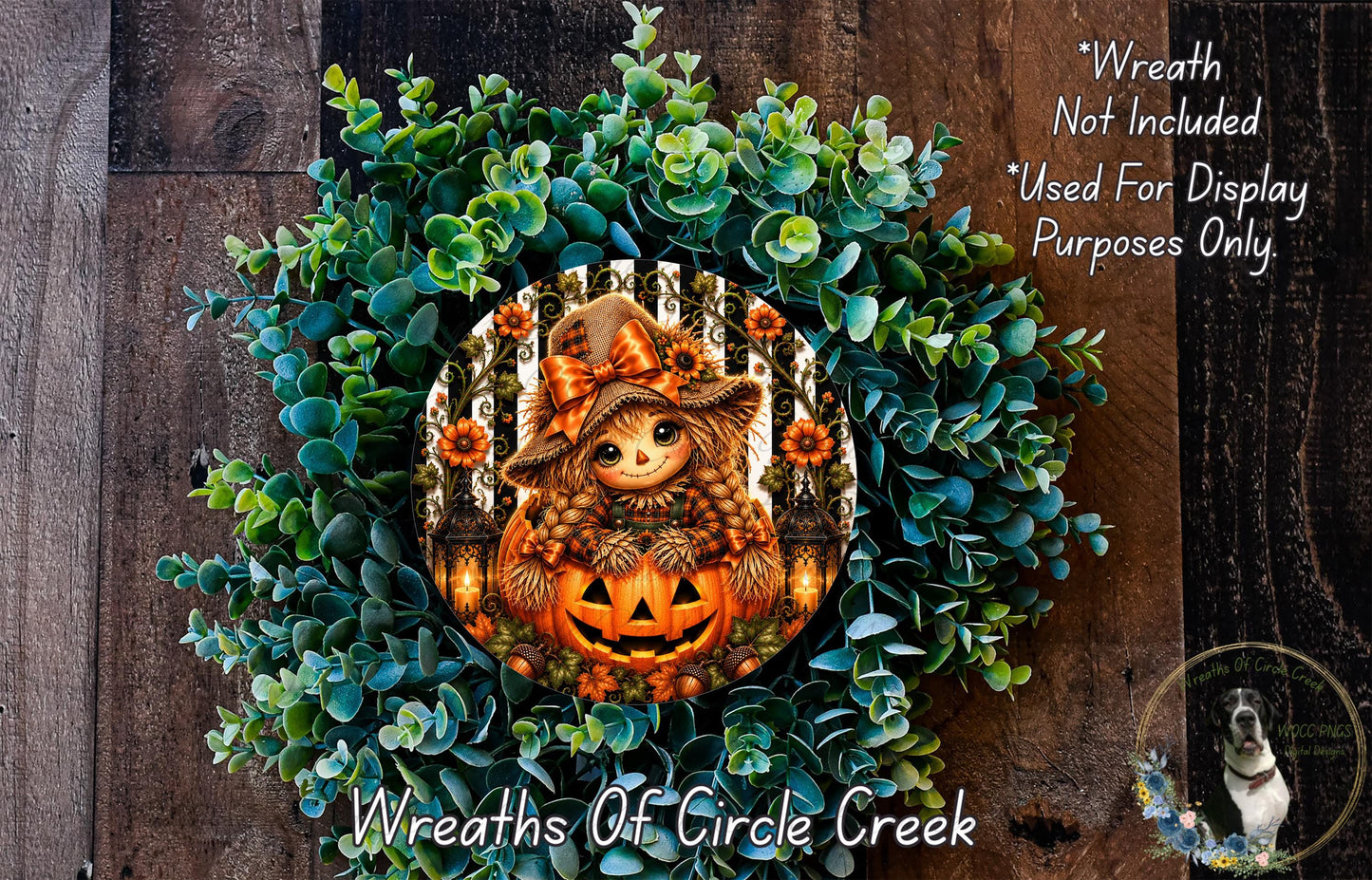 a Halloween-themed wreath with a pumpkin and a scarecrow design, surrounded by green foliage.