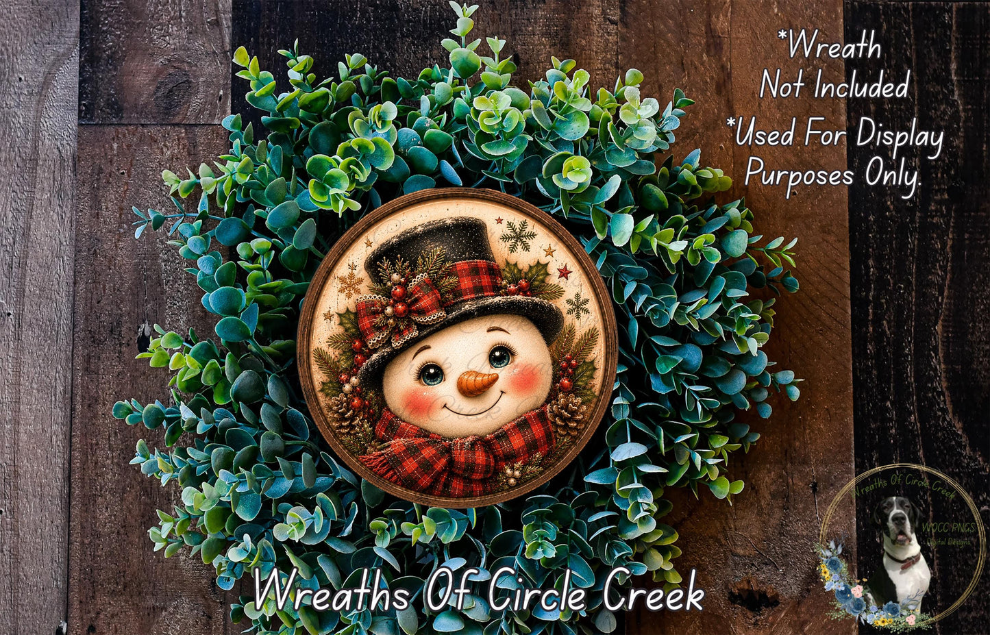 A wreath made of green plants and featuring a smiling snowman as the centerpiece.