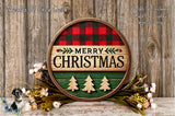 A circular wooden sign with the text "MERRY CHRISTMAS" in the center, surrounded by a plaid pattern and decorated with Christmas trees and flowers.