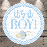 A round blue and white baby announcement sign with the text "It's a BOY!" and a pacifier icon.