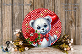 A round wreath with a white teddy bear holding a bouquet of red roses and a heart-shaped balloon, surrounded by a floral arrangement and a wooden background.