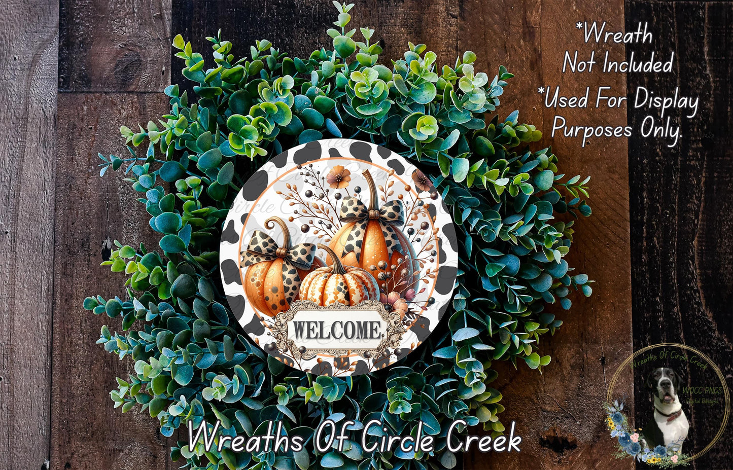a wreath made of various green plants and pumpkins, with a sign that says "Welcome" in the center. The wreath is displayed on a wooden surface, and there is a text overlay that reads "Wreath Not Included * Used For Display Purposes Only."