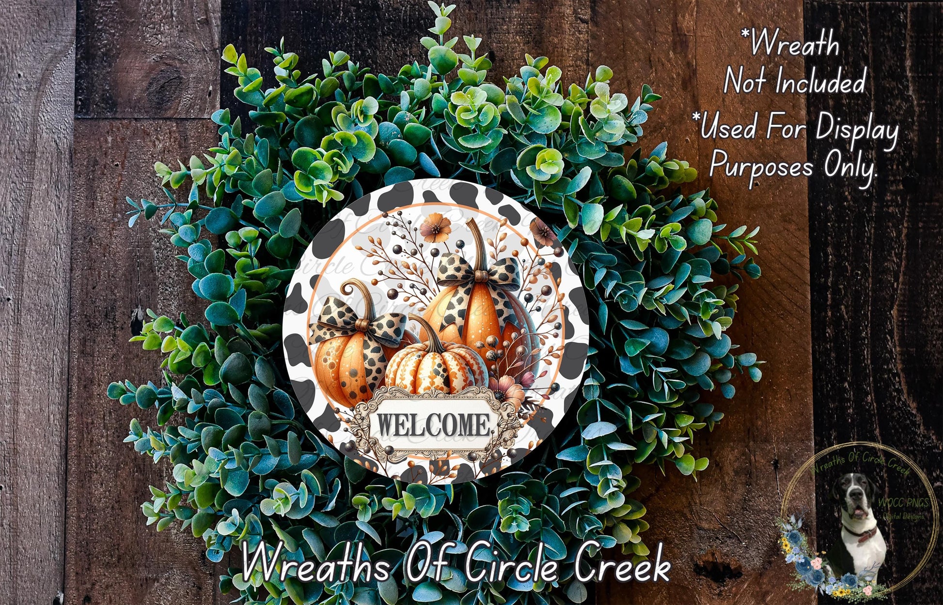 a wreath made of various green plants and pumpkins, with a sign that says "Welcome" in the center. The wreath is displayed on a wooden surface, and there is a text overlay that reads "Wreath Not Included * Used For Display Purposes Only."