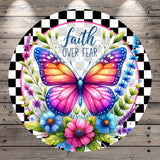 A colorful butterfly surrounded by flowers and leaves, with the text "Faith Over Fear" written above it.