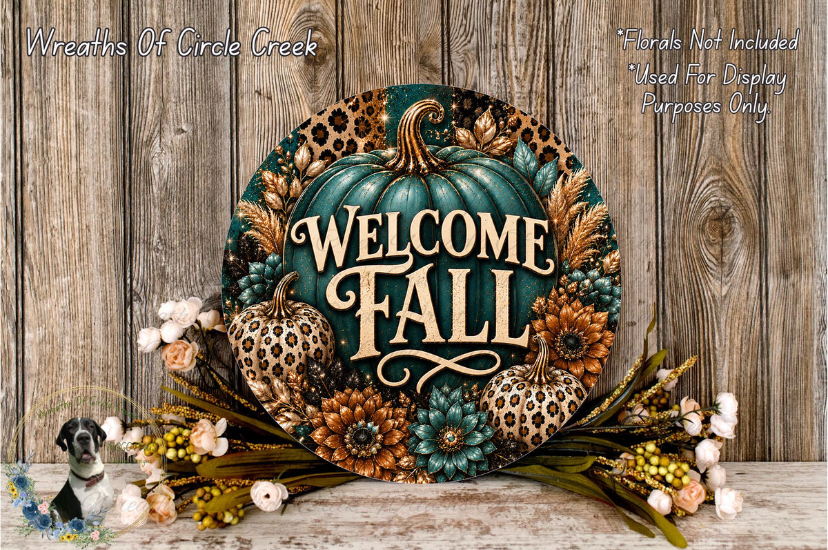 a decorative welcome sign with the text "Welcome Fall" surrounded by various fall-themed elements such as pumpkins, flowers, and leaves. The sign is placed on a wooden surface, and there is a small dog in the background.