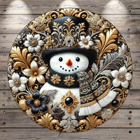 A decorative snowman with a black top hat and a scarf, surrounded by intricate floral and leaf designs in gold and black.