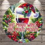 A festive Christmas-themed image with a glass of red wine, a red and white plaid hat, pine cones, berries, and a snowy background.