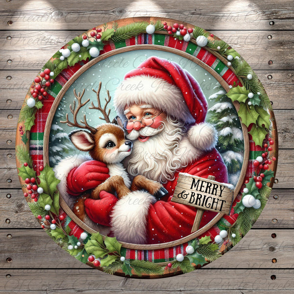 Santa Claus and his reindeer are depicted in a festive holiday scene, with Santa wearing a red suit and holding a reindeer. The background features a snowy landscape with pine trees and berries, and a wreath surrounds the image. A sign in the center of the image reads "MERRY & BRIGHT".