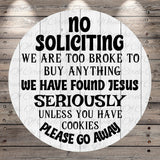a circular sign with a humorous and somewhat offensive message. The sign reads: "No Solicitation, We are too broke to buy anything we have found Jesus seriously unless you have cookies please go away".